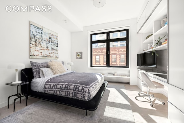 bedroom featuring light wood-style floors and baseboards