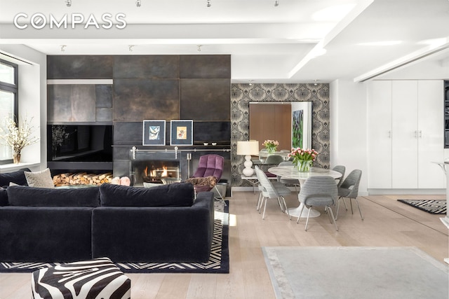 living area with a fireplace and wood finished floors