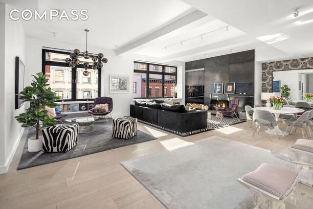 138 Reade St Unit 5, New York City, NY 10013 - living area featuring wood finished floors, baseboards, a chandelier, and beam ceiling