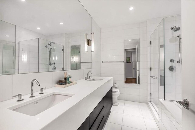 4 W 21st St Unit 10D, New York City, NY 10010 - bathroom featuring a shower stall, a sink, and tile walls