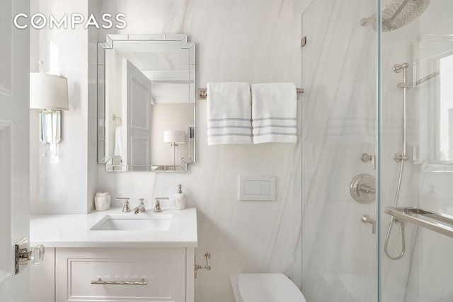 bathroom featuring vanity, a stall shower, and toilet