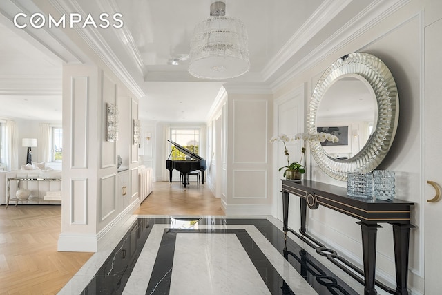 hall featuring crown molding and a decorative wall