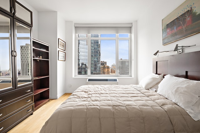 325 5th Ave Unit 34D, New York City, NY 10016 - bedroom with light wood-style floors, baseboards, and a view of city