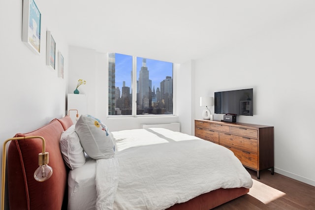 bedroom featuring wood finished floors and baseboards