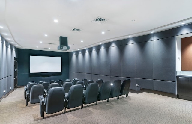 home theater room with light carpet, recessed lighting, and a decorative wall