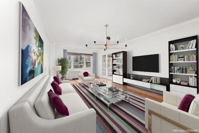living room featuring crown molding, a chandelier, and wood finished floors