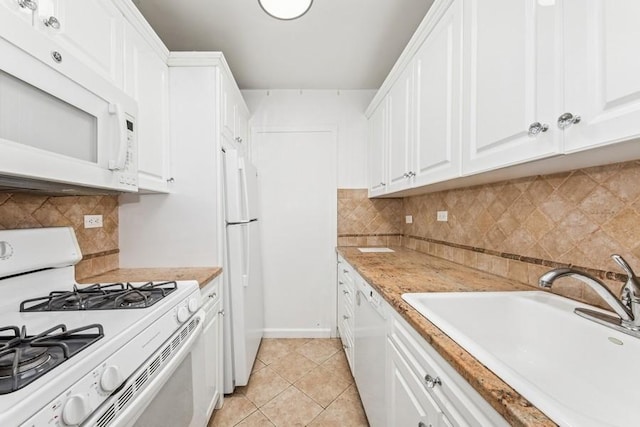 kitchen with light countertops, white appliances, white cabinetry, and a sink