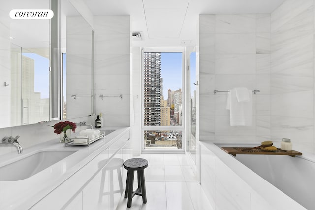 full bath with tile patterned flooring, a sink, double vanity, and a view of city