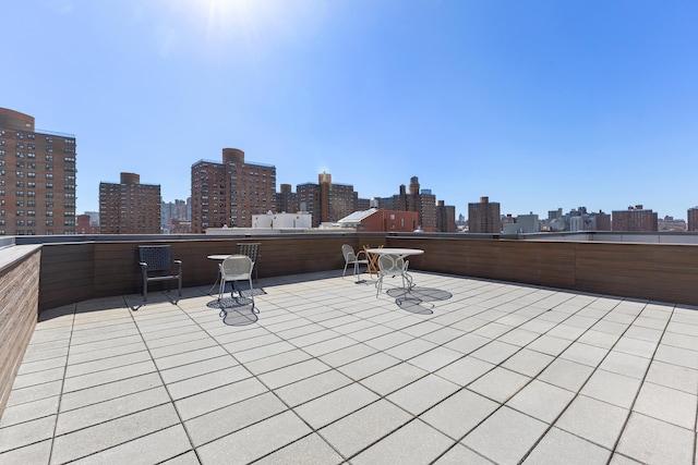 view of patio featuring a view of skyline and a balcony