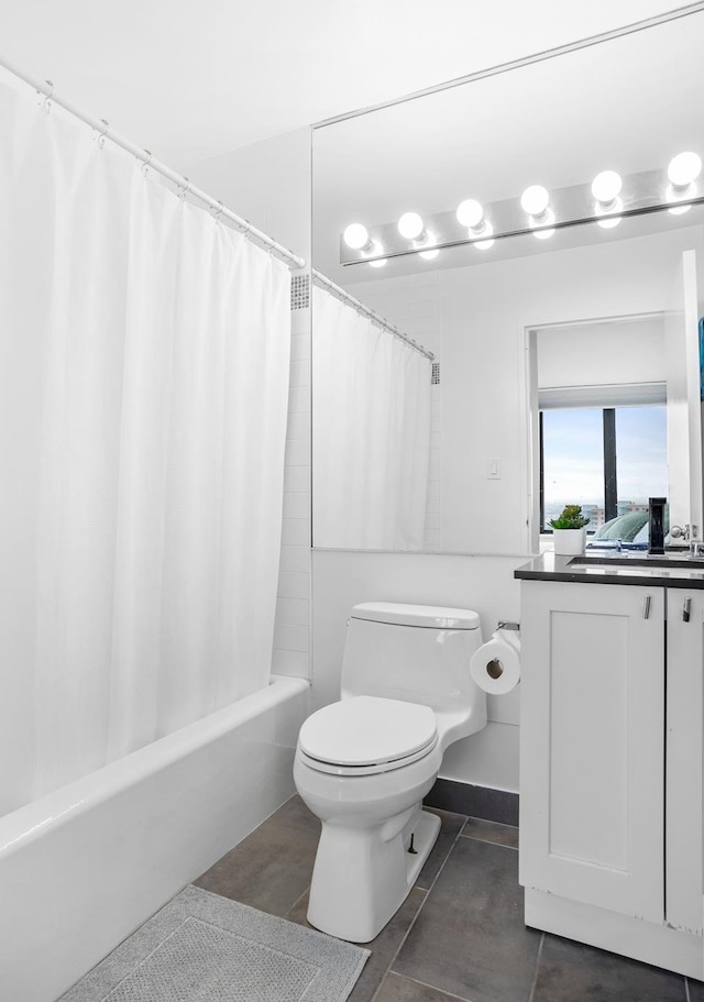 full bathroom with toilet, shower / tub combo with curtain, vanity, and tile patterned floors