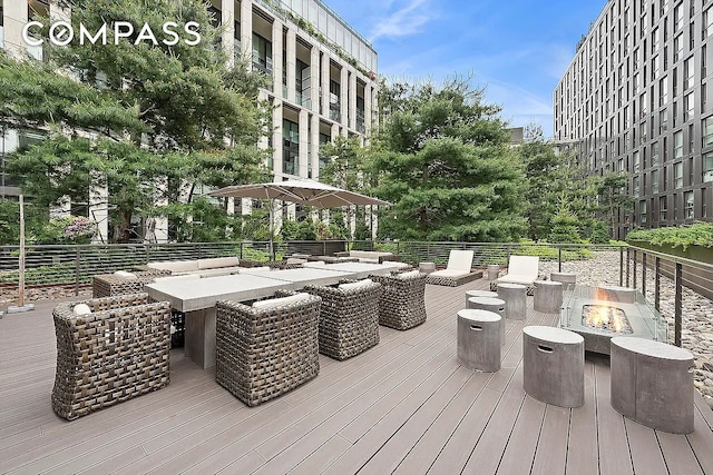 wooden terrace with an outdoor fire pit
