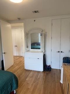 bedroom featuring light wood-style flooring and a closet