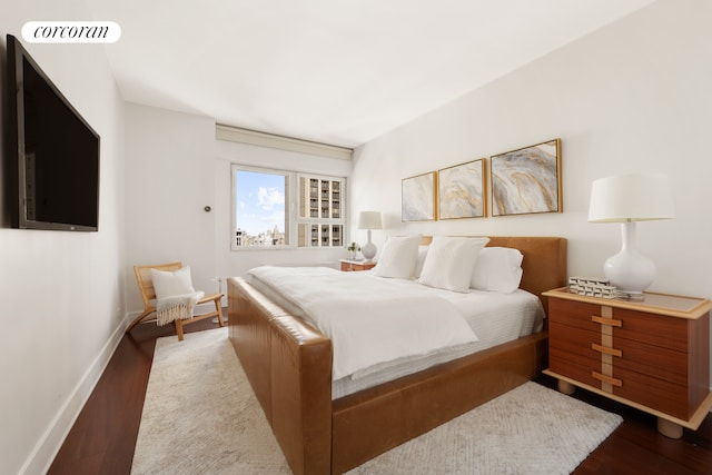 58 W 58th St Unit 24B, New York City, NY 10019 - bedroom with visible vents, baseboards, and dark wood-type flooring
