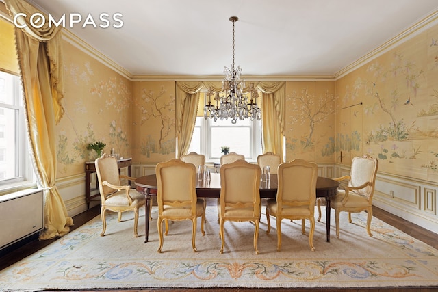 31 E 72nd St Unit 4B, New York City, NY 10021 - dining space with wallpapered walls, a chandelier, wood finished floors, a wainscoted wall, and ornamental molding