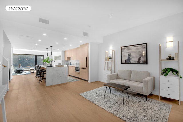 28 Huntington St, New York City, NY 11231 - living room featuring light wood-style flooring and recessed lighting