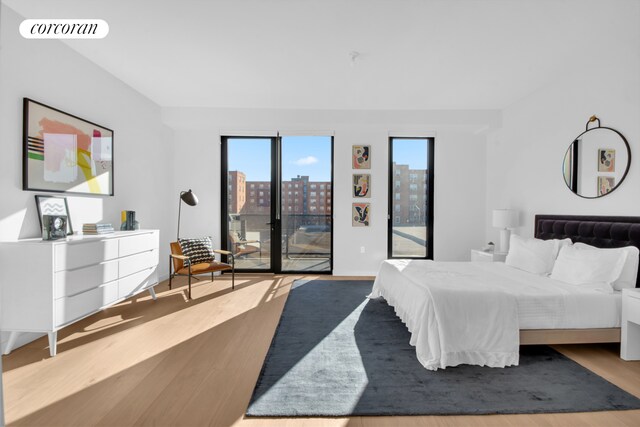 28 Huntington St, New York City, NY 11231 - bedroom with access to outside, wood finished floors, and a view of city