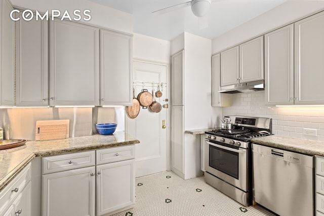 kitchen with white cabinets, under cabinet range hood, ceiling fan, and stainless steel appliances