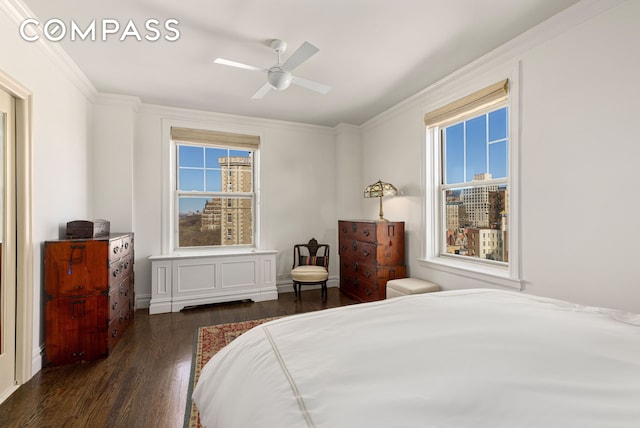 bedroom with multiple windows, wood finished floors, and crown molding