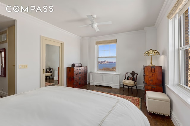 bedroom with dark wood-type flooring, crown molding, baseboards, and a ceiling fan