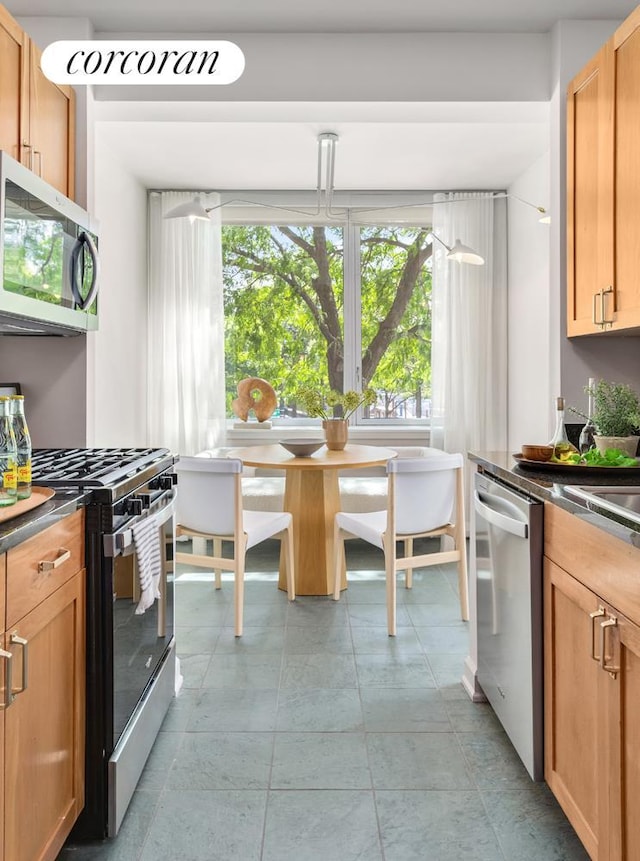 20 River Ter Unit 9M, New York City, NY 10282 - kitchen with dark countertops, light tile patterned flooring, and stainless steel appliances