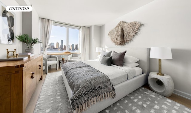 20 River Ter Unit 9M, New York City, NY 10282 - bedroom with a view of city, light wood-type flooring, and baseboards