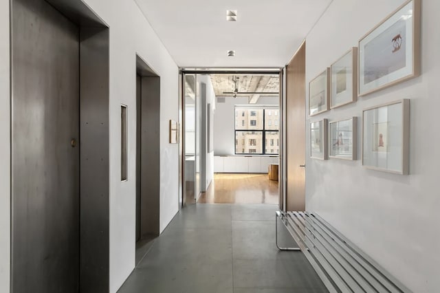 205 W 19th St Unit 11, New York City, NY 10011 - hallway featuring elevator and finished concrete floors