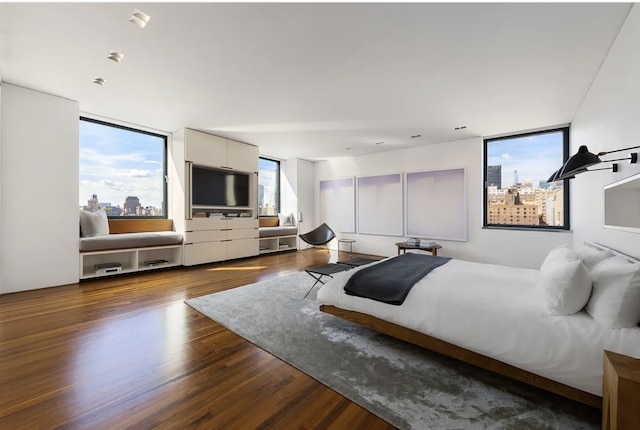 205 W 19th St Unit 11, New York City, NY 10011 - bedroom with dark wood-type flooring