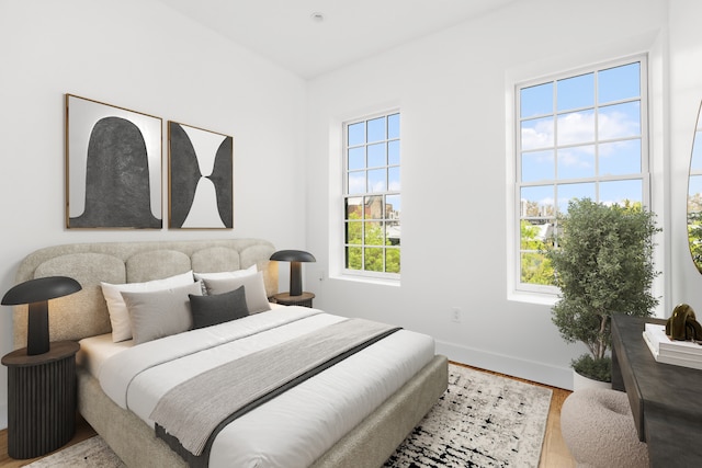 bedroom featuring baseboards and wood finished floors