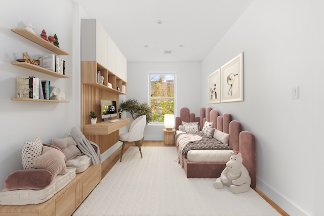 sitting room with baseboards, wood finished floors, and visible vents