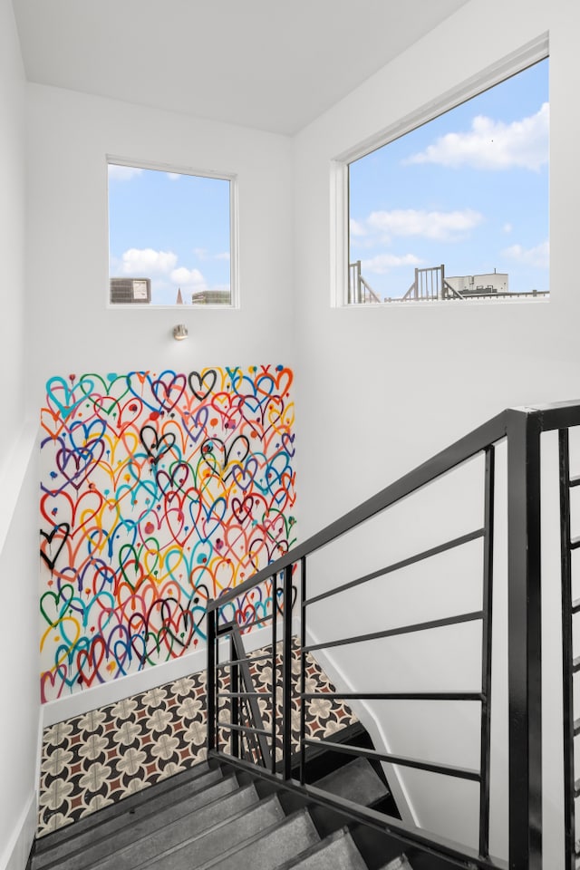 staircase with wood finished floors and baseboards