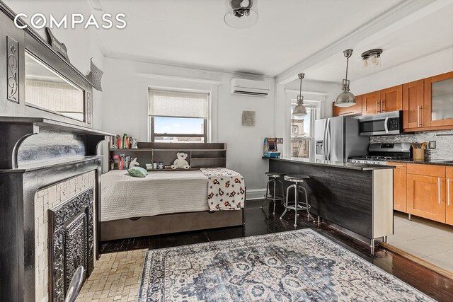 480A Mac Donough St, New York City, NY 11233 - bedroom featuring stainless steel fridge with ice dispenser, a fireplace, and a wall unit AC
