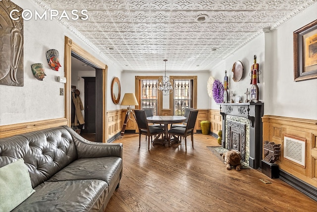 480A Mac Donough St, New York City, NY 11233 - dining space featuring an ornate ceiling, a chandelier, a wainscoted wall, ornamental molding, and hardwood / wood-style flooring