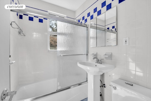 39-39 46th St, New York City, NY 11104 - full bathroom featuring tile walls, combined bath / shower with glass door, and toilet