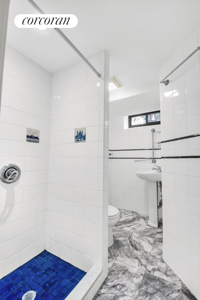 39-39 46th St, New York City, NY 11104 - bathroom with marble finish floor, toilet, tile walls, tiled shower, and a sink