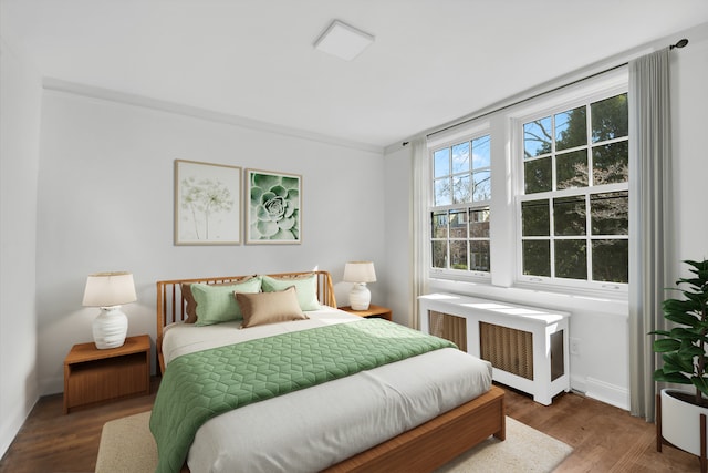 39-39 46th St, New York City, NY 11104 - bedroom featuring radiator heating unit, crown molding, and wood finished floors