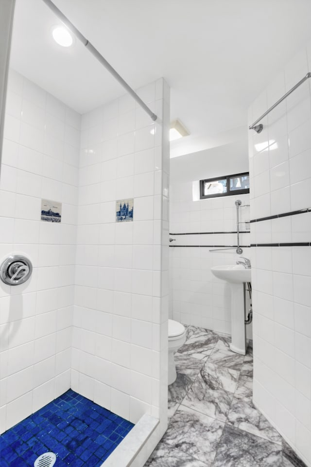 39-39 46th St, New York City, NY 11104 - full bathroom featuring tile walls, a sink, toilet, marble finish floor, and tiled shower