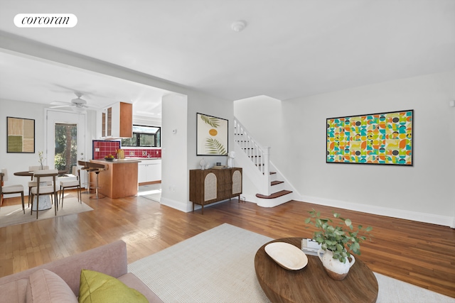 39-39 46th St, New York City, NY 11104 - living room with visible vents, a ceiling fan, wood finished floors, and stairway