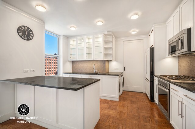 420 Riverside Dr Unit 12H, New York City, NY 10025 - kitchen with stainless steel appliances, a peninsula, open shelves, a sink, and white cabinets