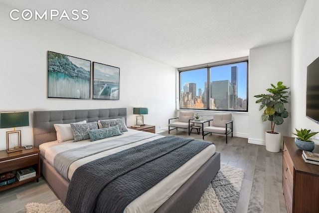 bedroom featuring wood finished floors and baseboards