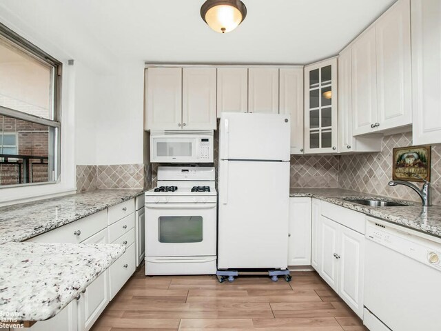 5800 Arlington Ave Unit 7L, New York City, NY 10471 - kitchen with white appliances, glass insert cabinets, a sink, and tasteful backsplash