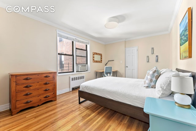 675 Academy St Unit 3A, New York City, NY 10034 - bedroom featuring radiator, ornamental molding, light wood-type flooring, baseboards, and cooling unit