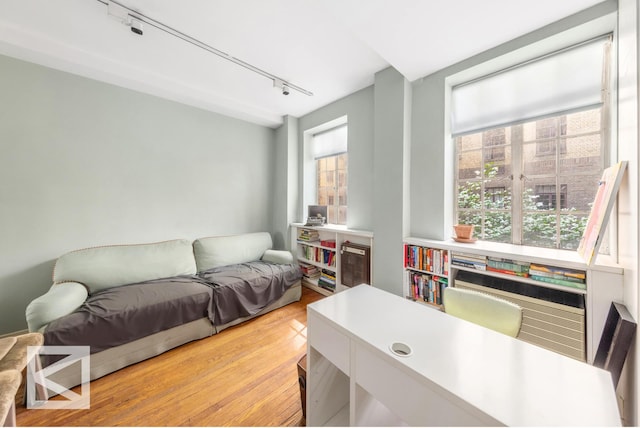 115 E 67th St Unit 3D/4D, New York City, NY 10065 - bedroom with rail lighting, multiple windows, and light wood-style flooring