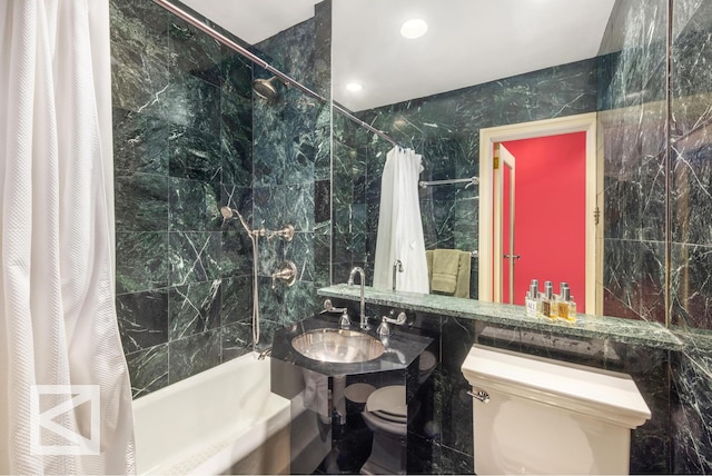 115 E 67th St Unit 3D/4D, New York City, NY 10065 - bathroom featuring toilet, a sink, tile walls, and shower / tub combo