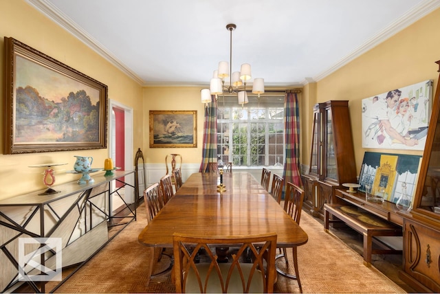 dining space featuring crown molding and a chandelier