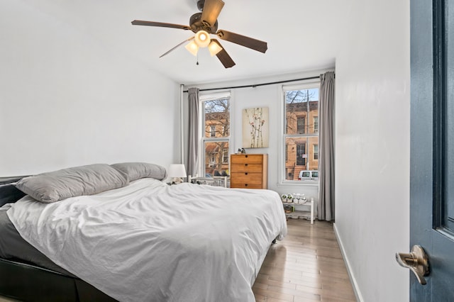 206A 29th St, New York City, NY 11232 - bedroom featuring ceiling fan, baseboards, and wood finished floors