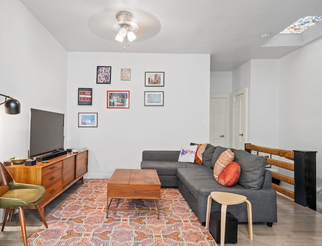 206A 29th St, New York City, NY 11232 - living room with ceiling fan, baseboards, wood finished floors, and a skylight