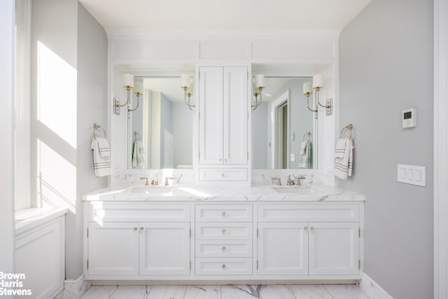 bathroom with marble look tiles and double vanity