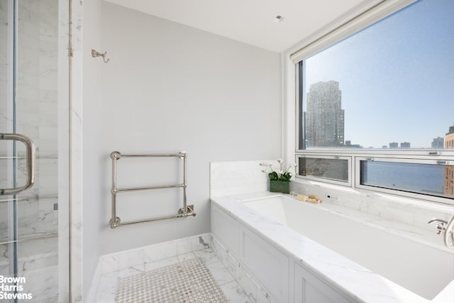 full bath with a marble finish shower, a bath, marble finish floors, baseboards, and a city view