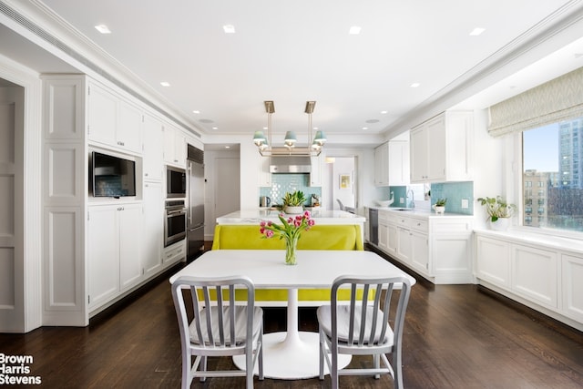 kitchen with oven, a sink, an island with sink, white cabinetry, and dark wood-style flooring