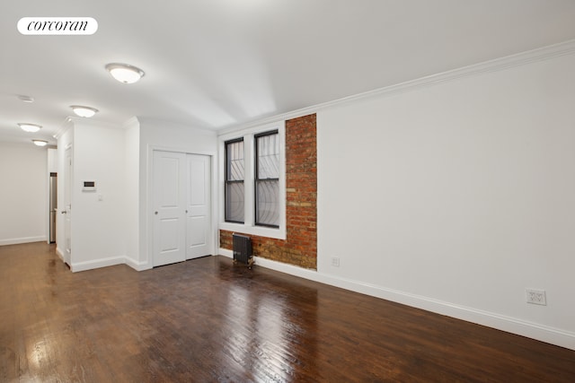 24-65 38th St Unit A5, New York City, NY 11103 - spare room with ornamental molding, baseboards, and wood finished floors